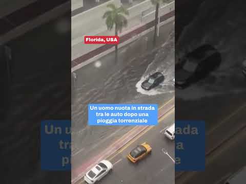 Florida pioggia torrenziale: un uomo nuota tra le auto