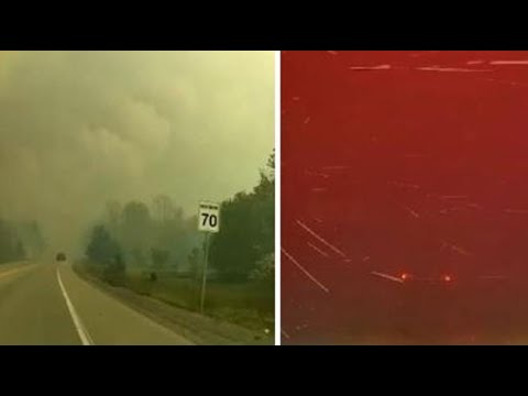 Incendio in Canada, un’auto attraversa una strada in mezzo alle fiamme